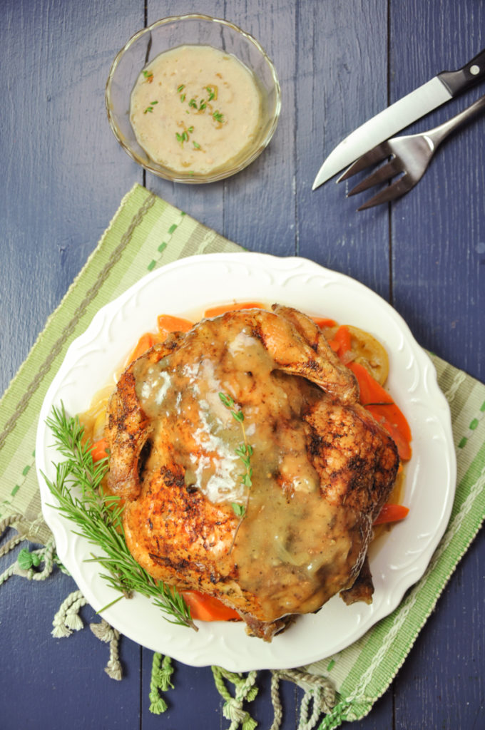 This lemon herb roasted chicken has perfectly crispy skin and tender, juicy meat. Seasoned with fresh lemon, herbs, and served with bone broth gravy. Low carb.
